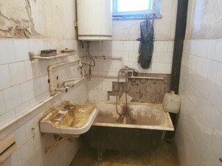 Dirty old bathroom. Ruined toilet ready for renovation