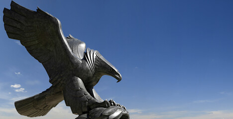 Sculpture of an eagle against the blue sky