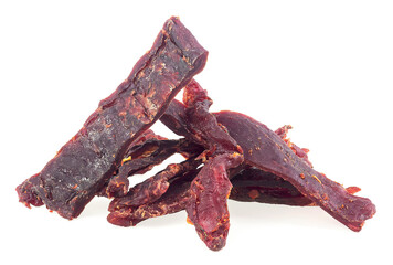 Portion of spiced beef jerky isolated on a white background. Dried peppered beef jerky.