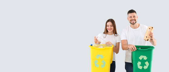 Couple sorting garbage on light background with space for text. Concept of recycling