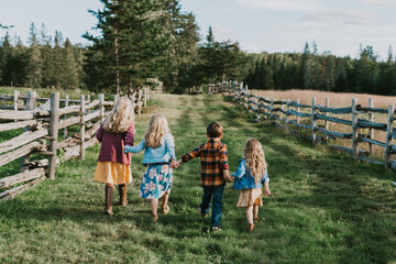 Back view of four siblings in the Doak House area, New Brunswick