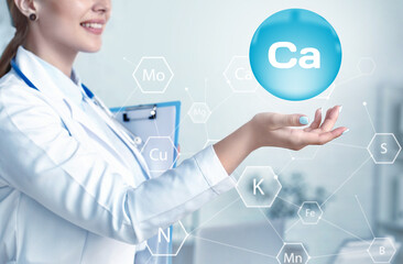 Fototapeta na wymiar Female doctor using virtual screen with chemical element Calcium in clinic