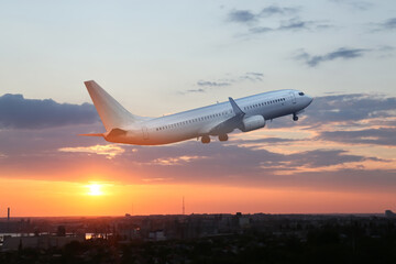 Fototapeta na wymiar View of flying airplane at sunset