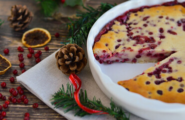 Traditional homemade Christmas cake on a white plate festive dessert with cranberries on the background of Christmas decorations