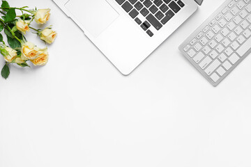 Laptop with computer keyboard and roses on white background - obrazy, fototapety, plakaty