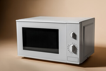Fototapeta premium White microwave oven on beige background