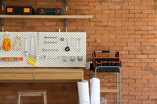 Desk and pegboard with tools in carpentry workshop