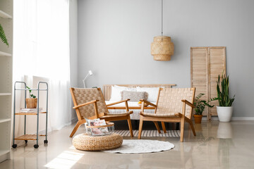 Interior of modern bedroom with wicker armchairs