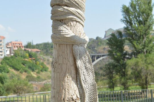 Closeup shot of a tree trunk wrapped in cloth in Tumo Park, Yerevan, Armenia