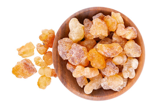 Frankincense resin in wooden bowl, isolated on white background. Pile of natural frankincense Olibanum. Incense. Top view.