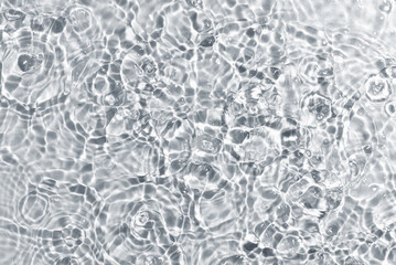 Texture of water with ripples on light background, closeup