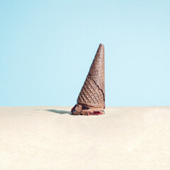 Melted chocolate ice cream in the beach sand.  Summertime. Vacation summer concept.