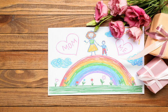 Picture with flowers and gift boxes on wooden background. Mother's Day celebration
