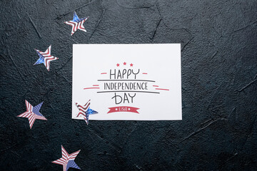 Greeting card with text HAPPY INDEPENDENCE DAY USA and stars on dark background
