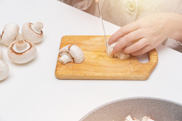 Process of cutting champagne on a wooden plate.