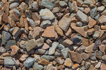 The texture of the stone. Brown and gray gravel is used for mulching the soil - obrazy, fototapety, plakaty