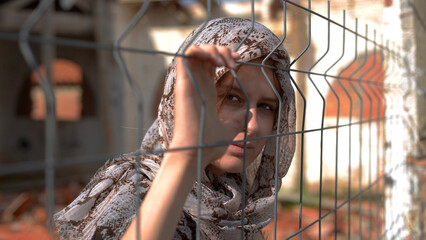 Selective focus shot of a white muslin refugee being held in captivity