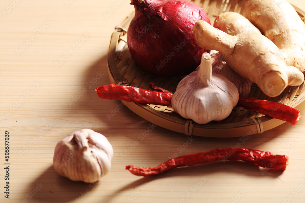 Poster ginger, garlic and red pepper in the bamboo basket