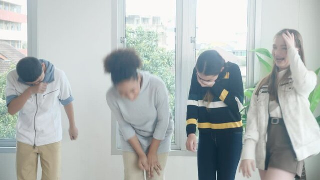 Group of student doing activity to teacher with dancing and movement together in the school, back to school, pupils learning exercise with enjoy and laughing, acting and emotion, education concept.