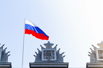 Russian flag. State flag of the Russian Federation against the blue sky.