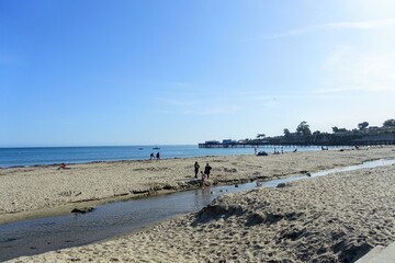 People enjoying a beautiful evening with views of Monterey Bay, along the beachfront of Capitola,...