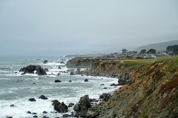 Fototapeta na wymiar A beautiful view of the rugged shoreline of the northern california coast driving along highway 1, with rugged endless views of the ocean and rocky cliffs