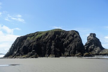 A beautiful view of Bandon beach in Bandon, Oregon, with the headlands and beautiful coast exposed at low tide for people to explore