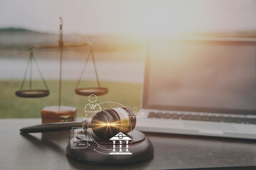 Justice and law concept.Male judge in a courtroom with the gavel, working with, computer and...