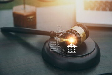 Justice and law concept.Male judge in a courtroom with the gavel, working with, computer and...