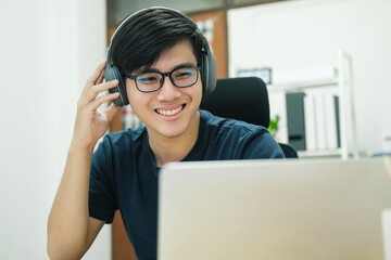 Young man study in front of the laptop computer at home