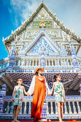 Naklejka premium Happy family travel in Wat Pak Nam Khaem Nu temple