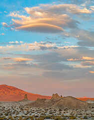 the sun is setting and coloring the clouds over the Trona Pinnacles in the Mojave Desert ,California
