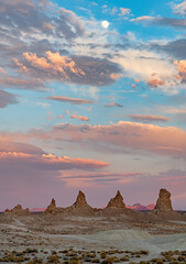 the sun is setting and coloring the clouds over the Trona Pinnacles in the Mojave Desert ,California
