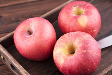 Three red apples and a fruit knife