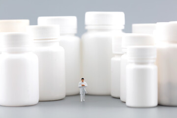 Miniature creative doctor saves man and medicine bottle