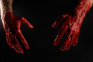 Male bloody hands on a black background.  © Михаил Решетников