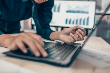 Investors working on desk office and use computer keyboard and laptop  to check data cost, balance,...
