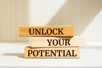 Wooden blocks with words 'Unlock Your Potential'.