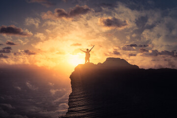 silhouette of a person on the top of the mountain with arms up to the sunrise. Freedom adventure in nature concept. 