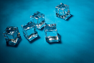 Clear ice cubes for cooling drinks on a blue background.