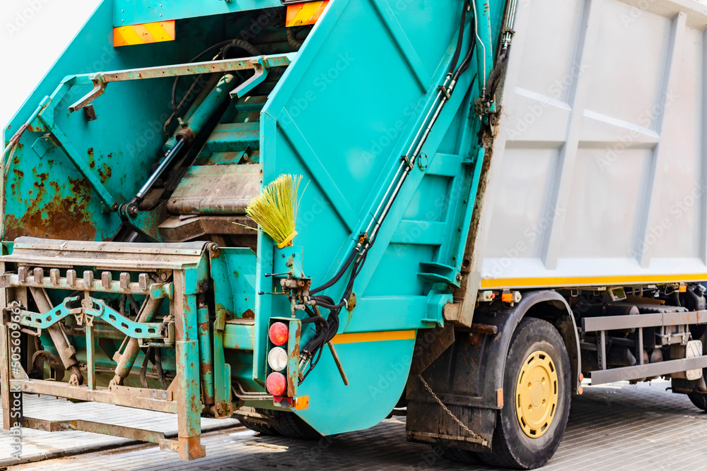 Poster A garbage truck picks up garbage in a residential area. Loading mussar in containers into the car. Separate collection and disposal of garbage. Garbage collection vehicle.