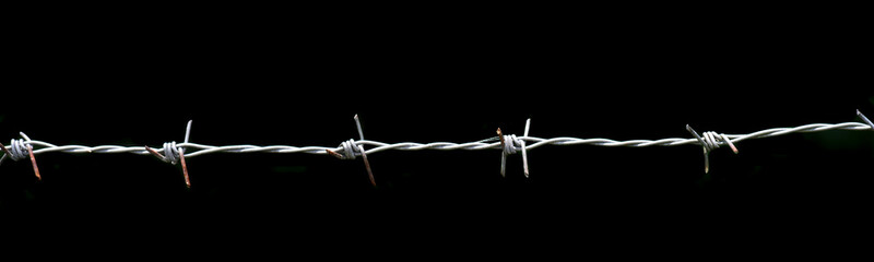 barbed wire fence on black background