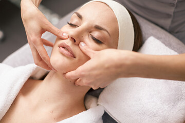 Fototapeta na wymiar girl getting a therapeutic facial massage in a spa salon