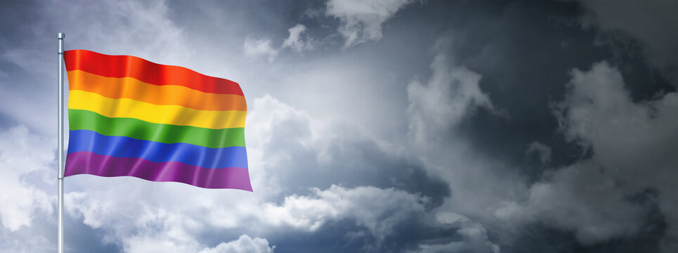 Rainbow gay pride flag on a cloudy sky