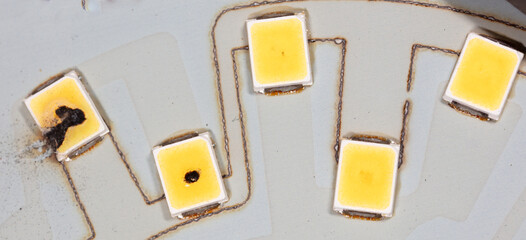 Burnt out LEDs on a disassembled LED lamp.