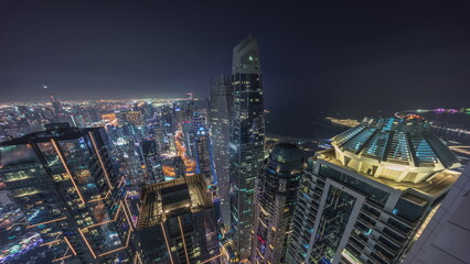Fototapeta na wymiar Aerial view of JBR and Dubai Marina skyscrapers and luxury buildings night timelapse from above