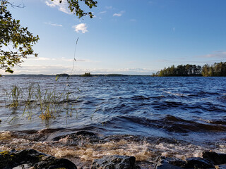 Waves hitting rocks on Lake Saimaa in eastern Finland on a sunny summer evening.