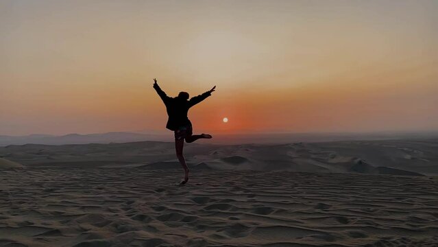 woman running happy in the desert at sunset. freedom