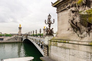 Lateral view of Alexander Bridge over the Seine River in central Paris on a cloudy day