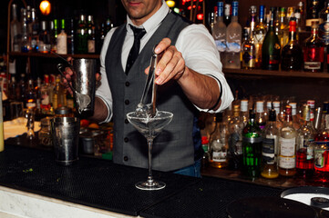 Barman prepares cocktails in the nightclub.